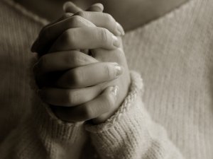 rigid woman praying hands